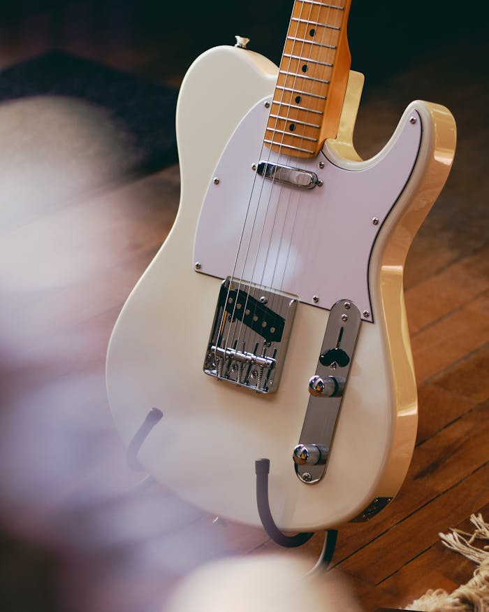 Mastering the First Impression: Your intriguing post title goes here A detailed view of a vintage electric guitar resting on a wooden floor, showcasing classic design.
