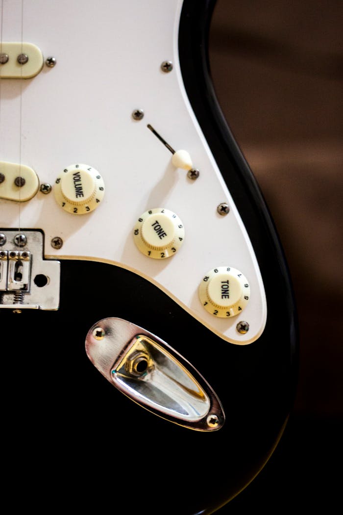 The Art of Drawing Readers In: Your attractive post title goes here Detailed view of an electric guitar body showing volume and tone control knobs.